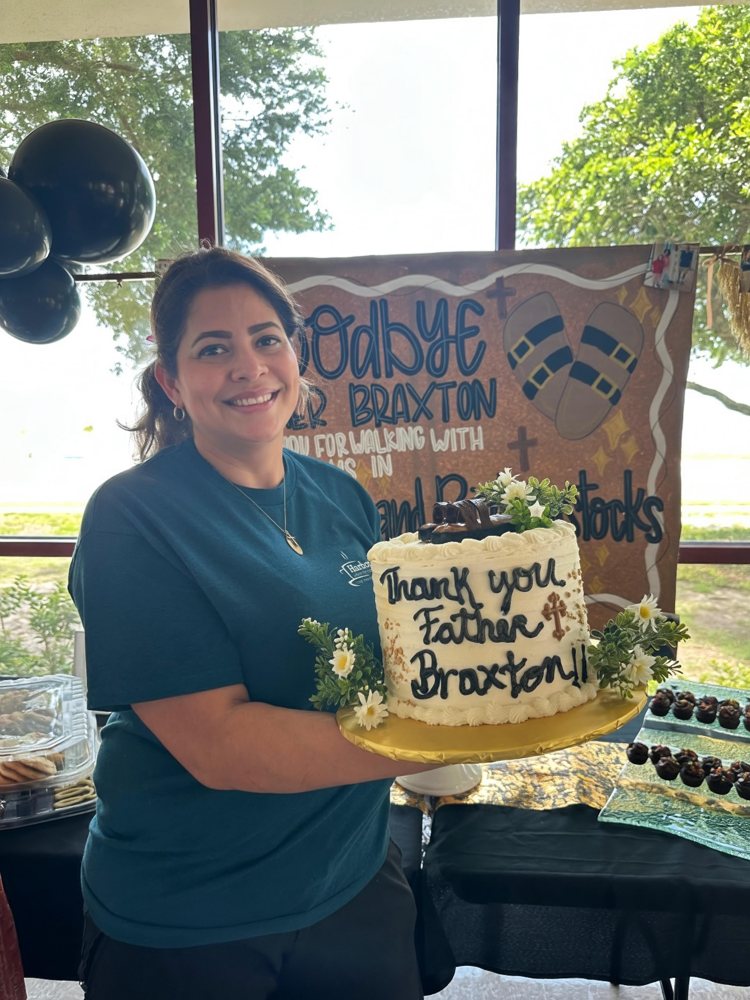 Tere holding a freshly decorated cake